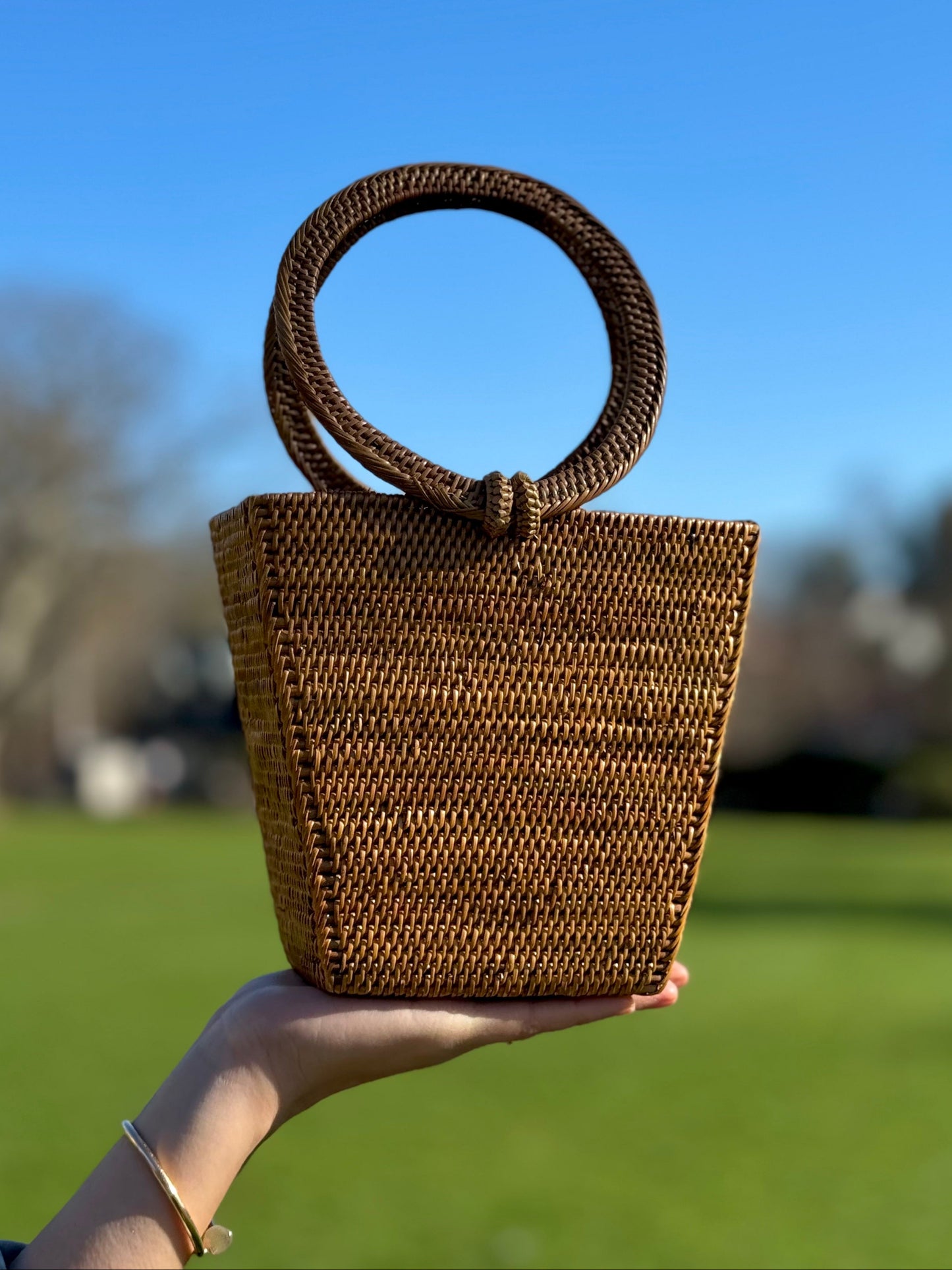 Model holding a Galia rattan bag
