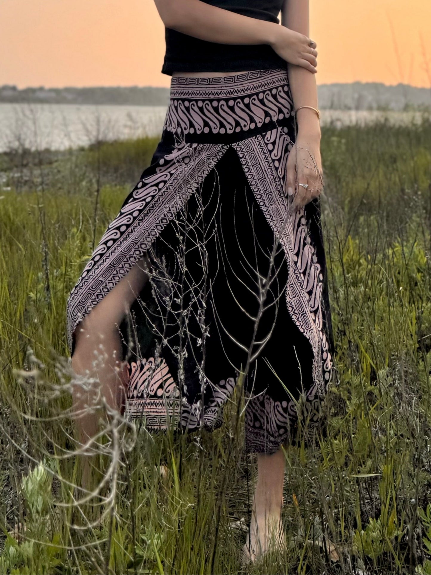 Close up of black Hanna capri pants with high slit design.