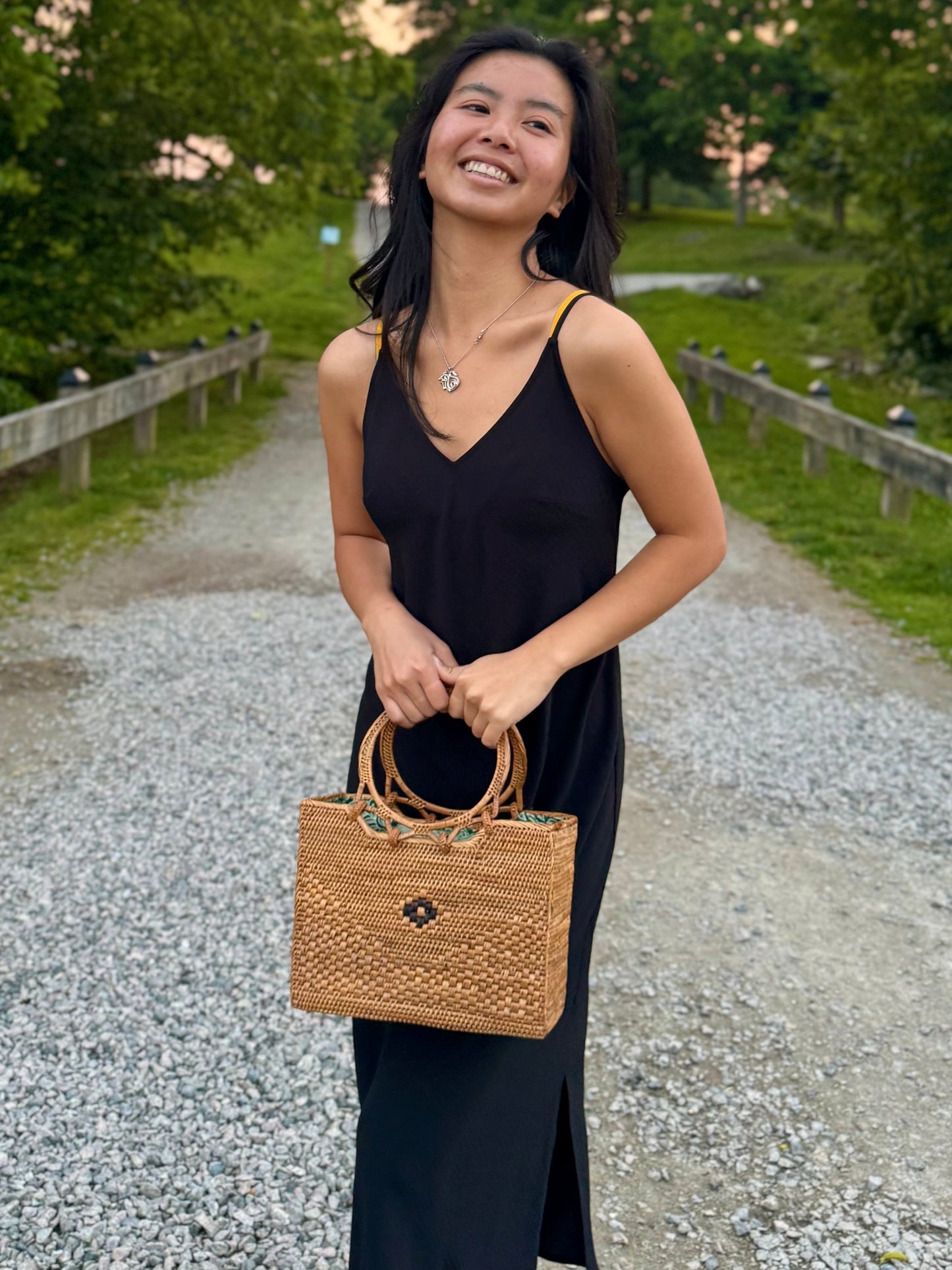 Model carrying a rattan ata bag from the front