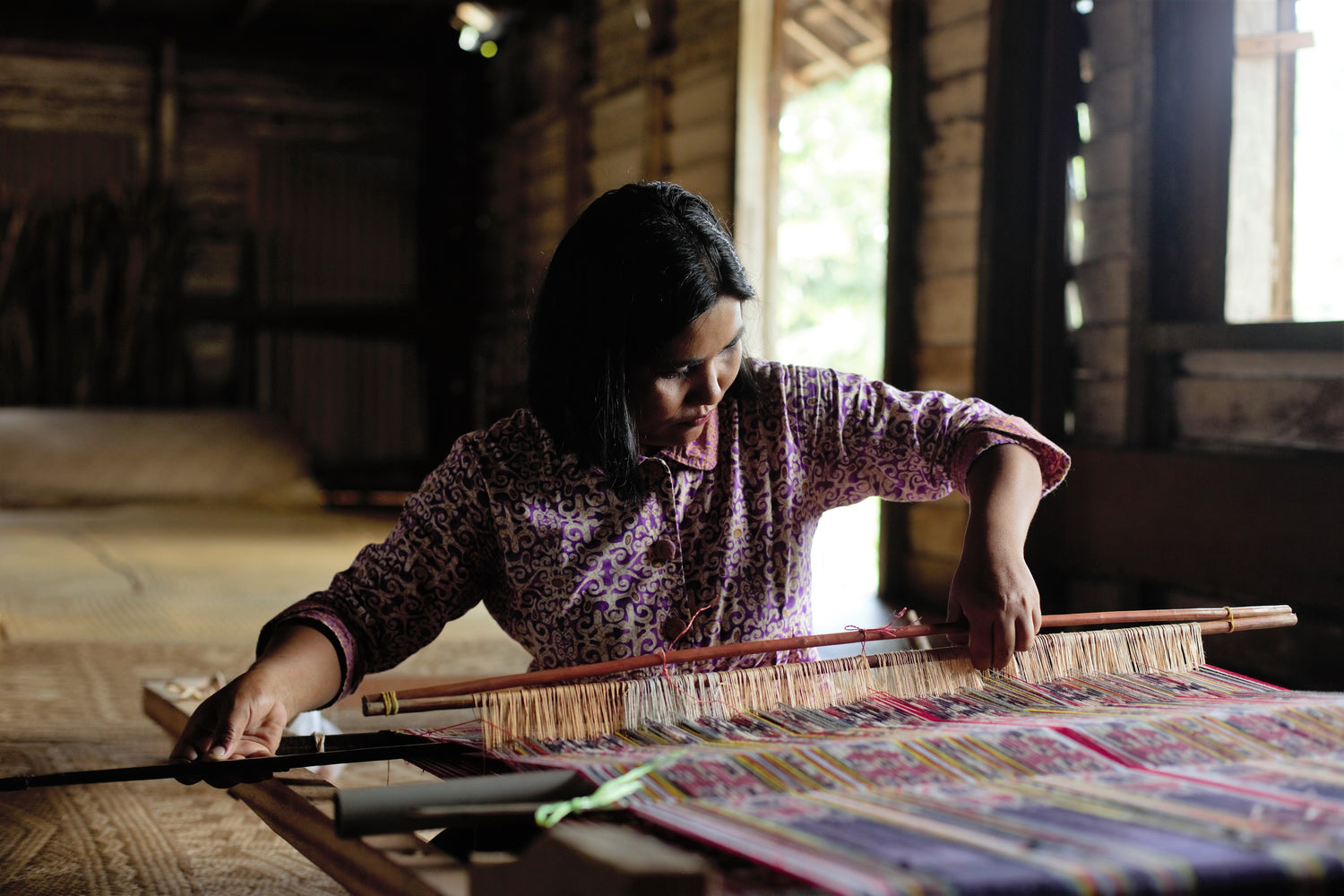 Photo of a woman weaving