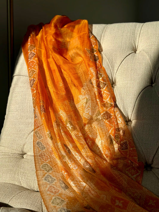 Orange Silk Scarf draped over chair, glossy and luxurious
