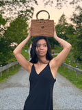 Model posing with ata vine bag placed on top of her head