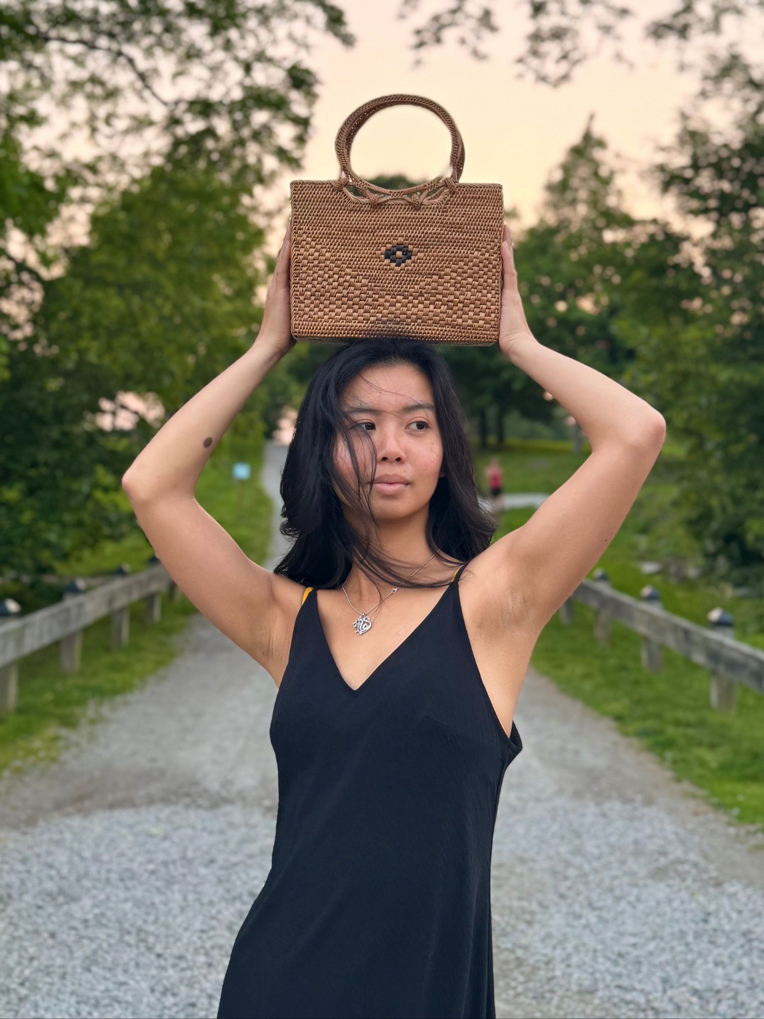 Model posing with ata vine bag placed on top of her head