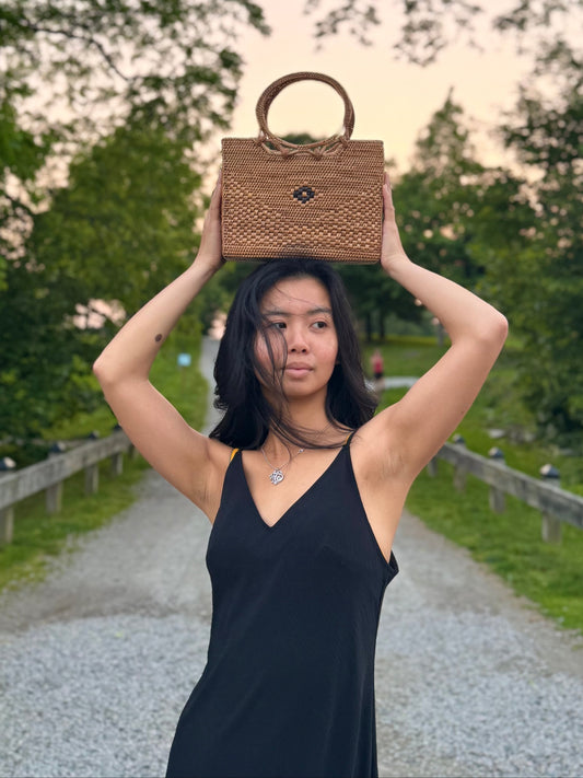 Model posing with ata vine bag placed on top of her head
