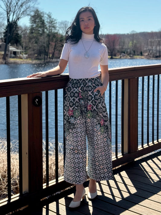 Model wearing Dark Green Nami Barrel Pants on a bridge.