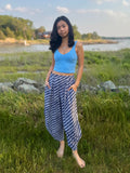 Model wearing Dewi Yoga Pants in Black standing in a grassy field