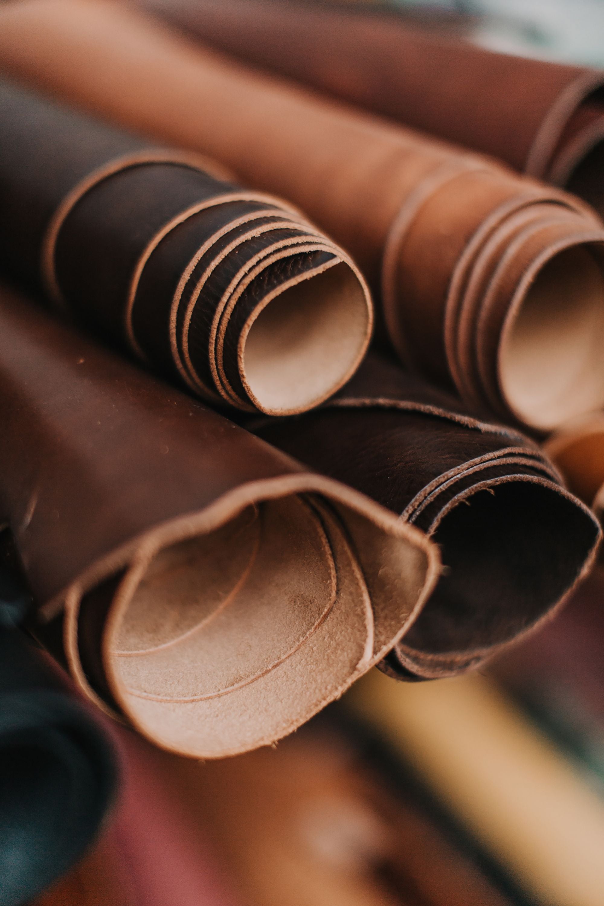 Rolled pieces of brown leather stacked together