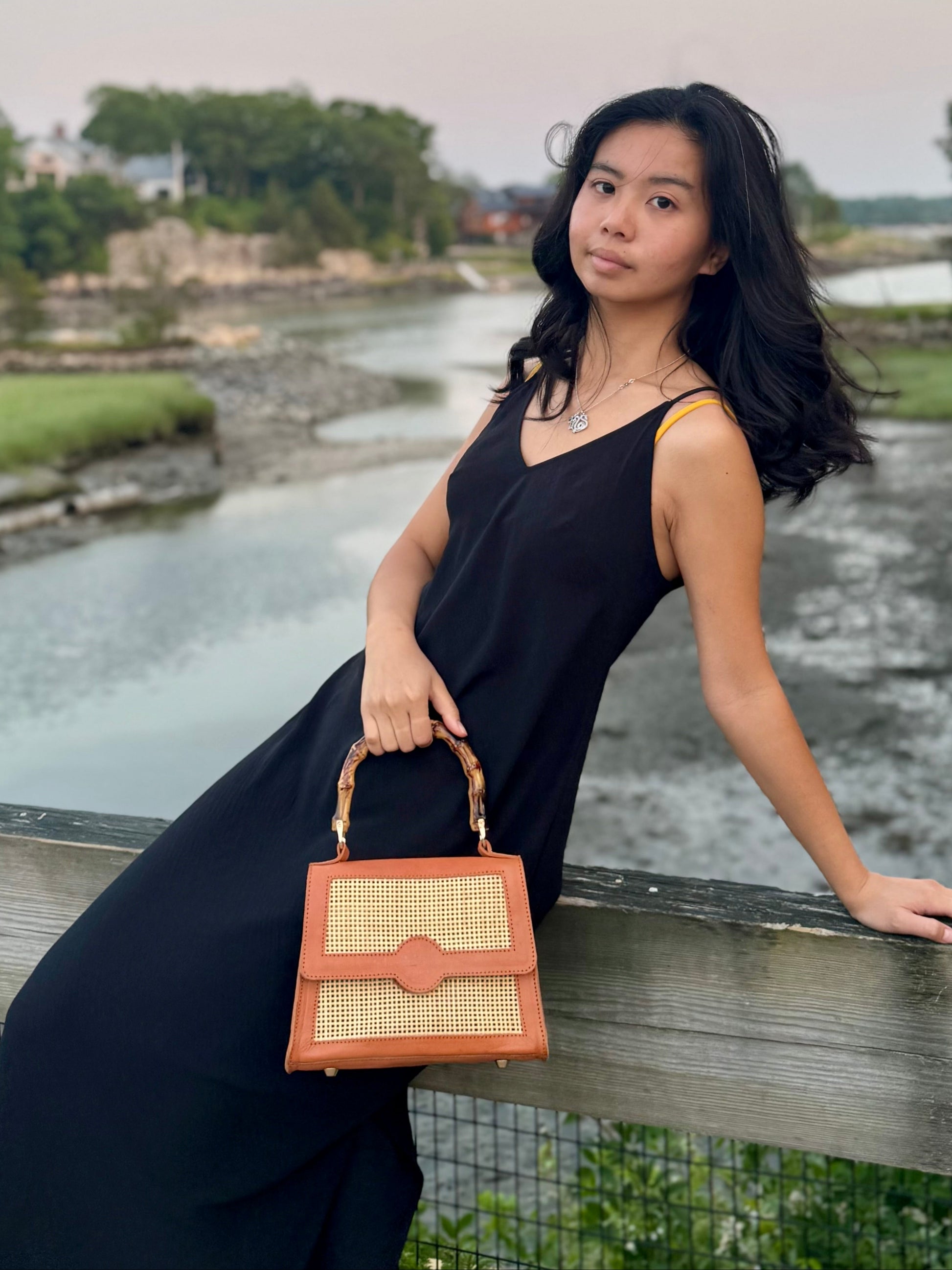Model holding the maya bag by the seaside