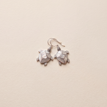 Pair of earrings on a beige background