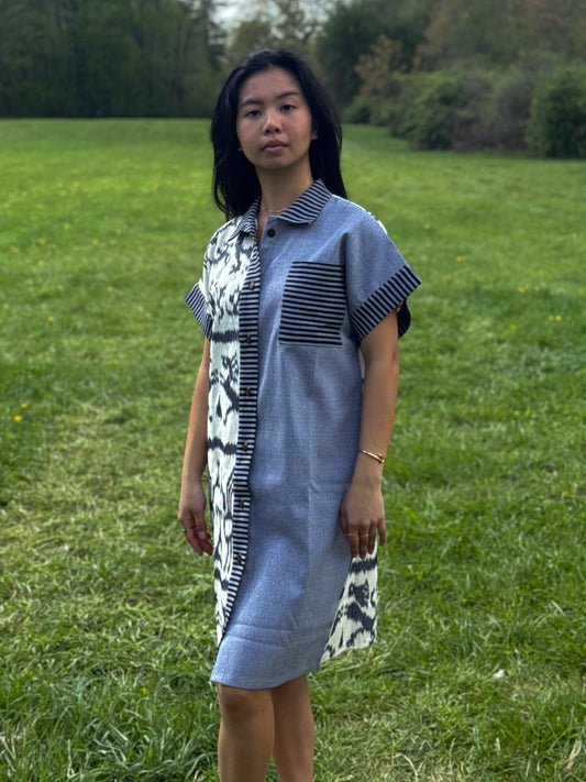Model wearing Tenun Dress Shirt featuring mixed tenun standing on a green grass.